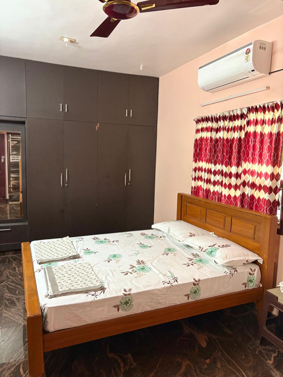 Air-conditioned bedroom with double bed and wardrobe
